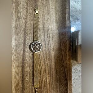 Stella & Dot gold bracelet with unique enamel charm